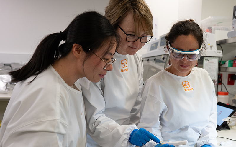 Three female scientists looking at the active syphilis test.