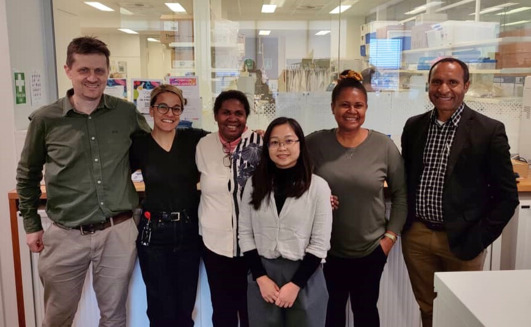 Jennifer Kopania Banamu was one of the inaugural recipients of the Evelyn Lavu Travel Scholarship. She visited Australia in 2024 and is pictured here with researchers at The Peter Doherty Institute for Infection and Immunity. Pictured is Lachlan Coin, Sharon Trevor, Jennifer Kopania Banamu, An Nguyen, Nomin-Dora Tenakanai and Rendi Moke.